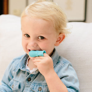 Toddler using whale baby finger toothbrush