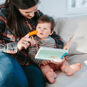 Mum using The Brushies silicone toothbrush to clean baby's teeth - Brushie + The Brushies Book - Mums Toolbox